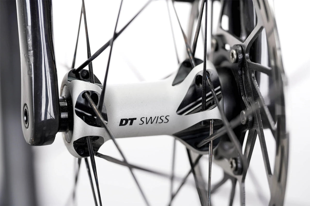 Suncrest Pro close-up of a white DT Swiss front hub beside the fork leg