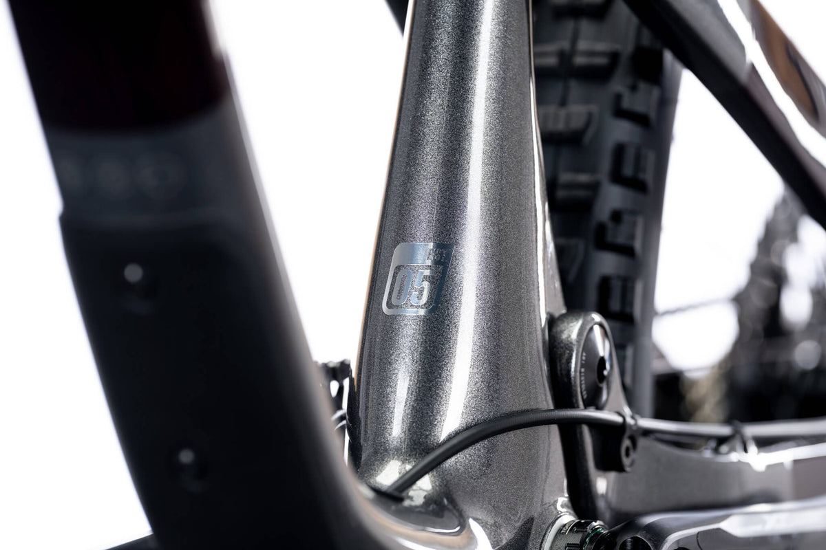 Seat tube and cable guide on a silver-gray Ari La Sal frame with a 05 badge, close-up