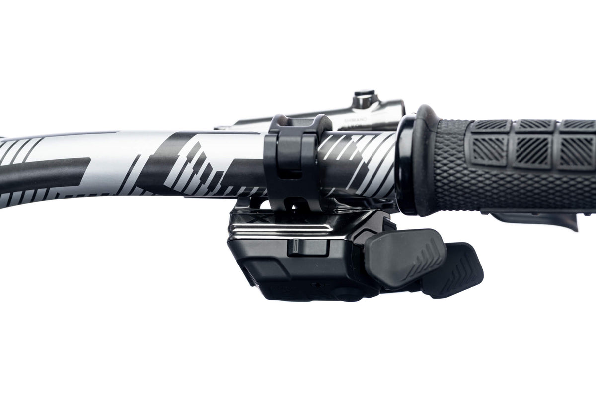 Wireless shifter paddle, grip and clamp on an Ari La Sal handlebar, close-up