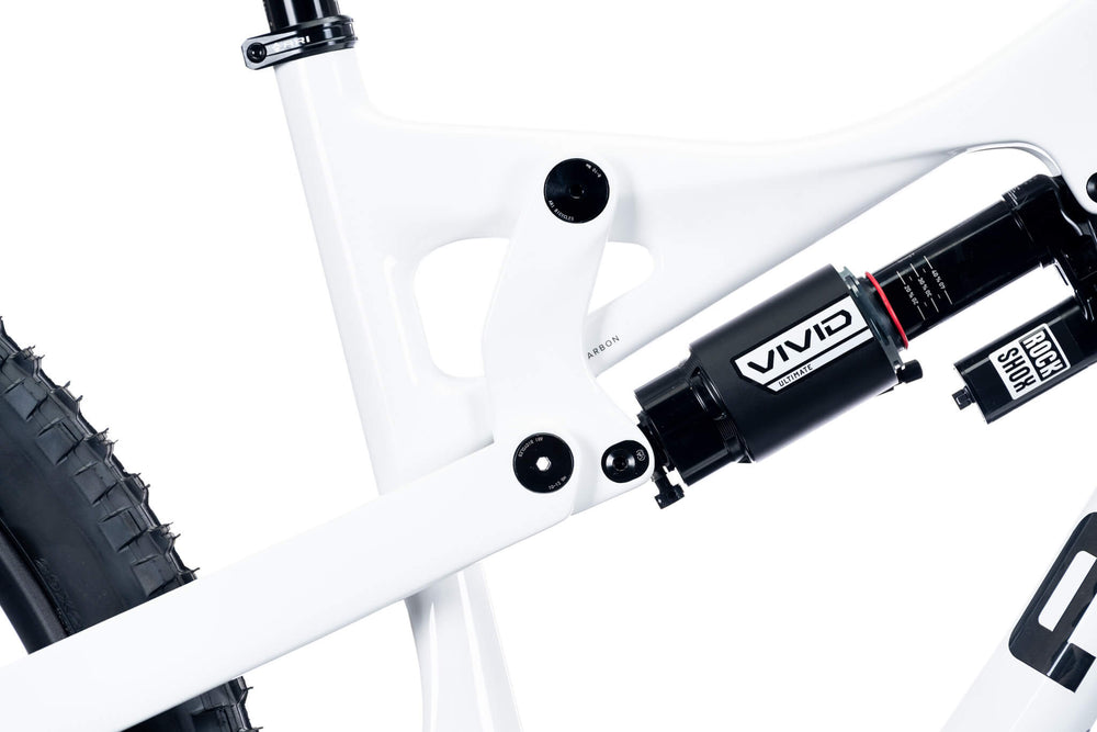 Rocker link and Vivid rear shock on a white Ari La Sal frame, close-up