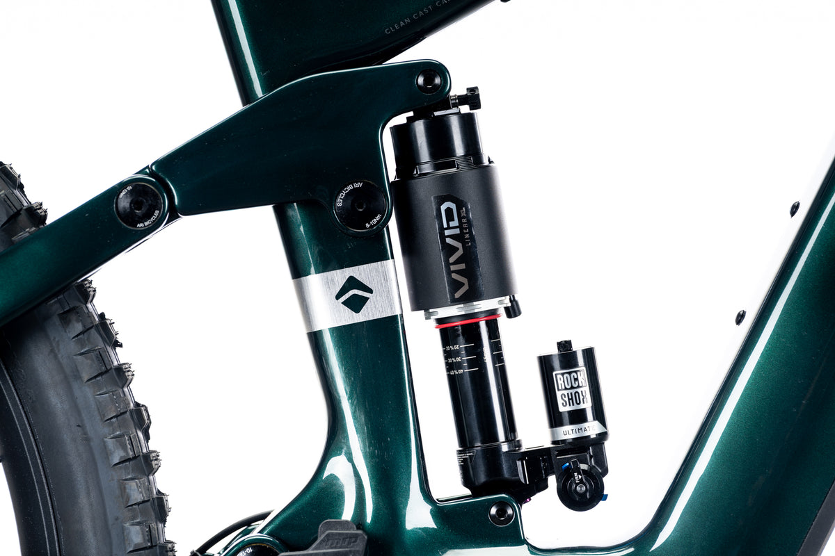 RockShox Vivid rear shock and linkage on a teal green Timp Peak frame