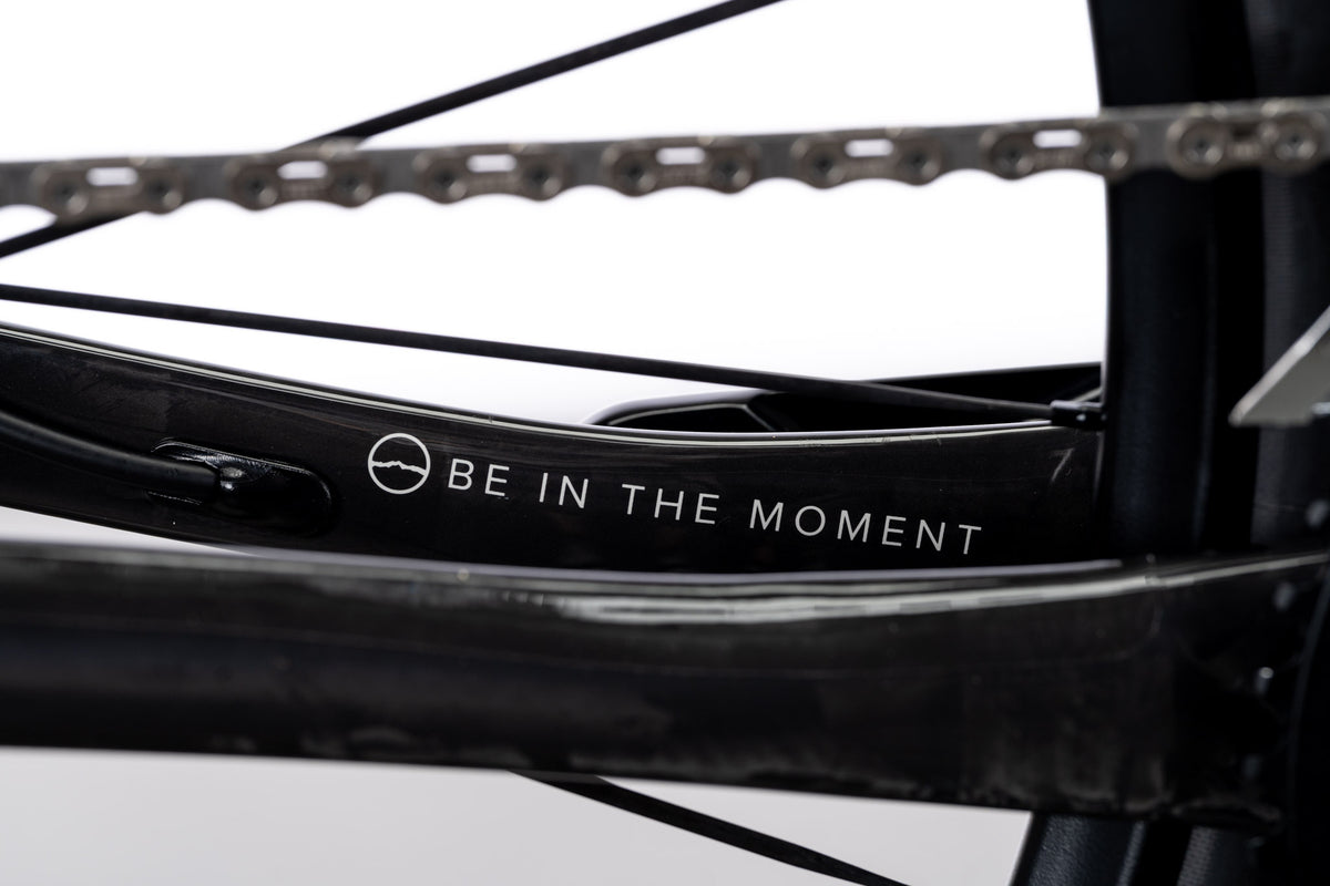 Black Veyo chainstay with Be in the Moment text and the chain above it