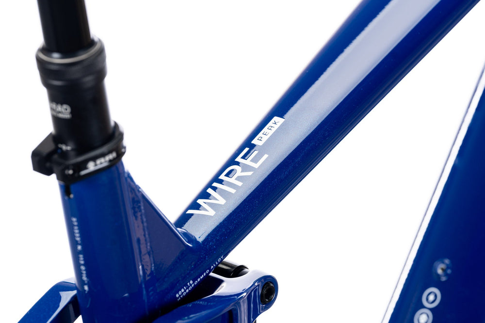 Blue Wire Peak seat tube and top tube junction with the Wire Peak decal and dropper post