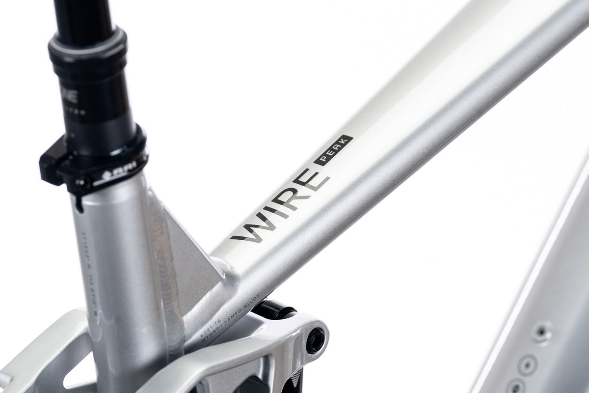 Silver Wire Peak seat tube junction with the Wire Peak decal and dropper post