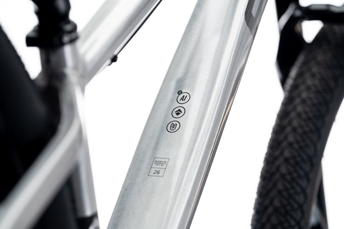 Silver 801 down tube with icon decals and a size 26 label, tire behind