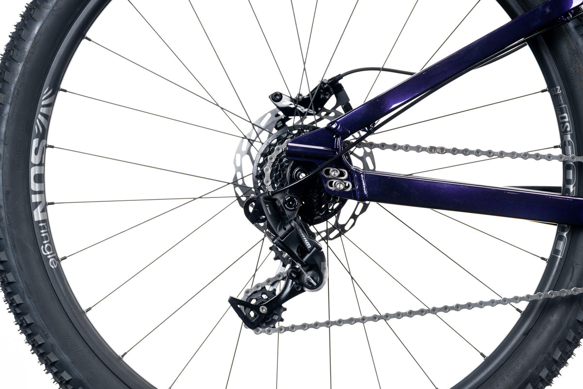 Dark purple 801 rear dropout with derailleur, chain and spoked rear wheel