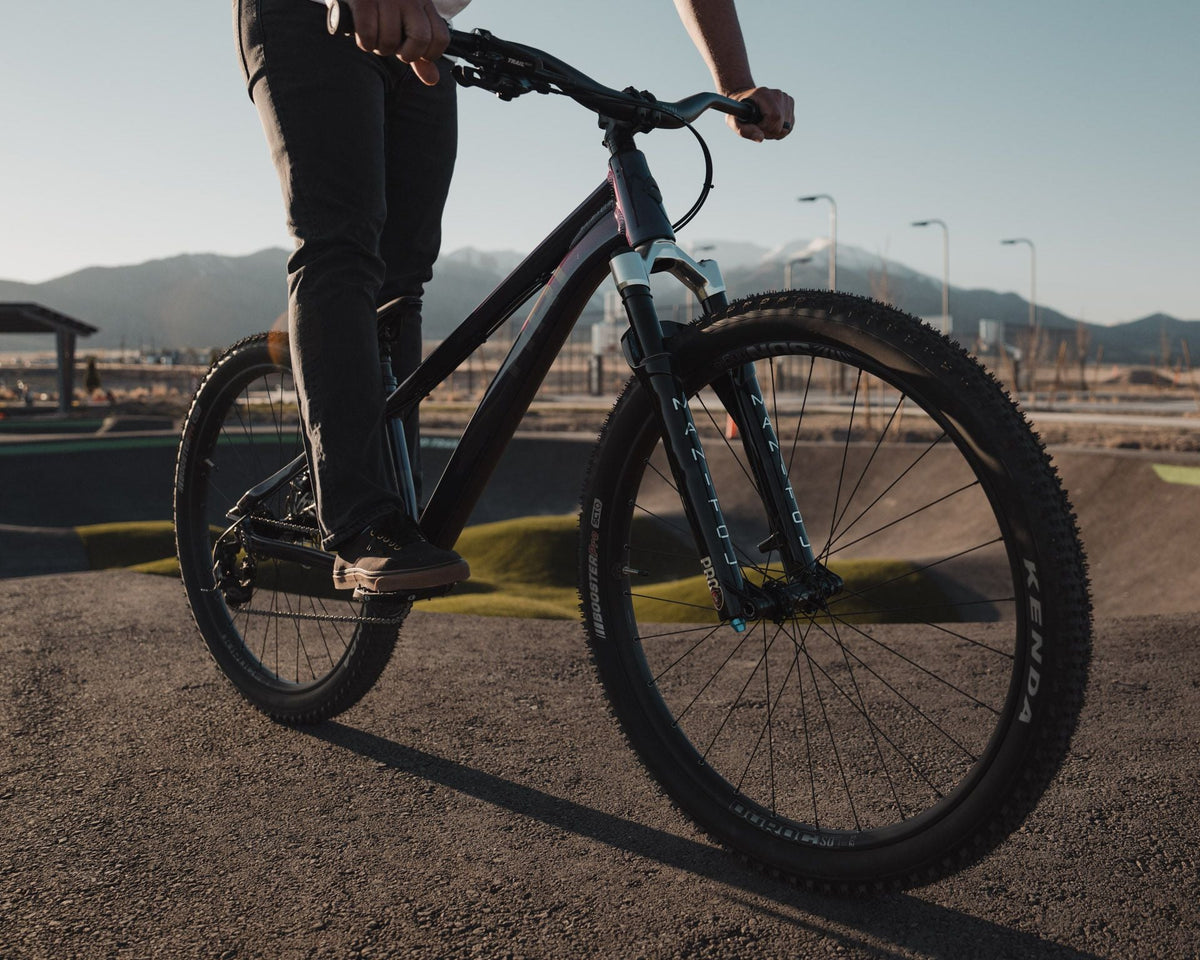Rider rolling the 801 across a paved pump track