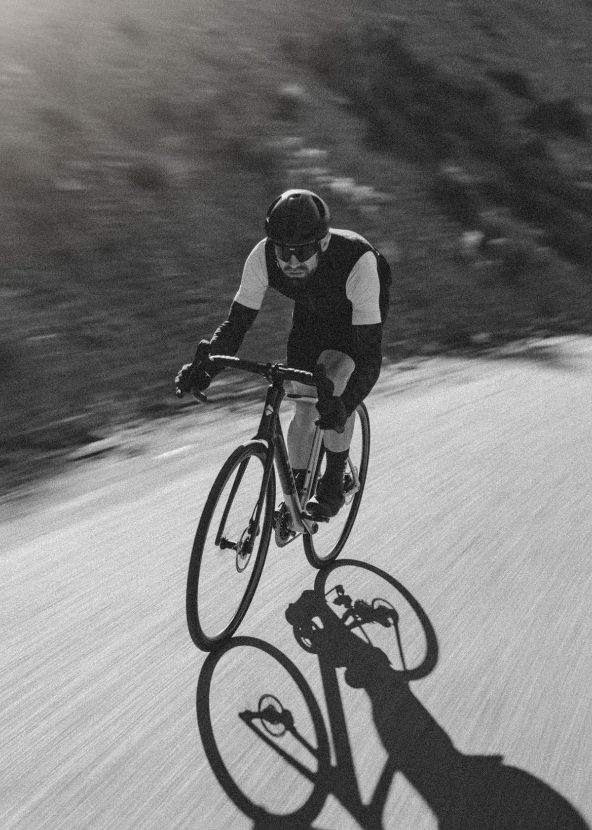 Black-and-white shot of a rider descending on the Suncrest with a long shadow